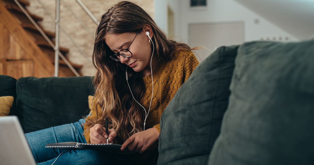 woman note taking in her book